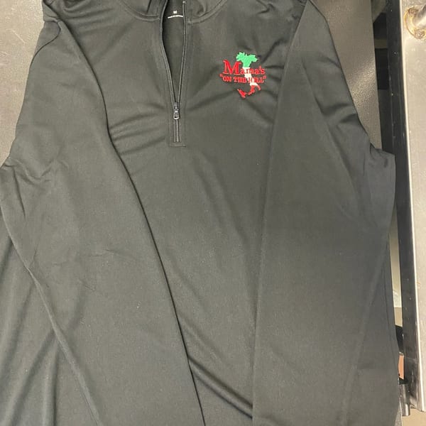 Black long-sleeved shirt with a zipper, featuring the "Mama's On The Hill" logo.