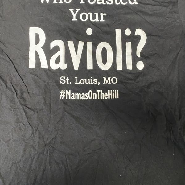 Black t-shirt with white text: "Who Toasted Your Ravioli? St. Louis, MO #MamasOnTheHill"